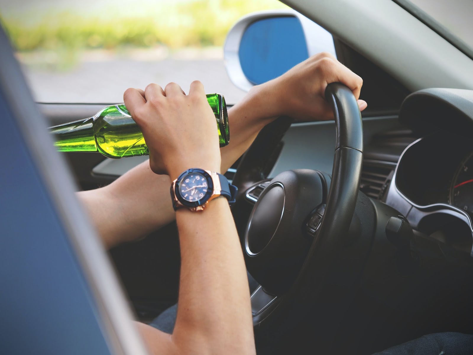 A motorist drinking while driving a car